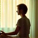 Person in a peaceful meditation pose, bathed in soft, warm light.